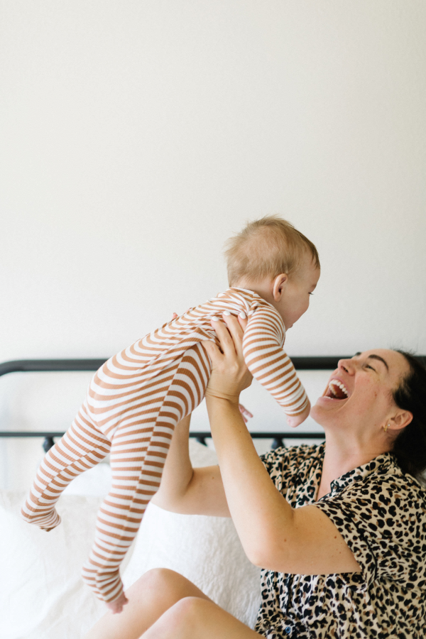 a smiling mother holding an infant